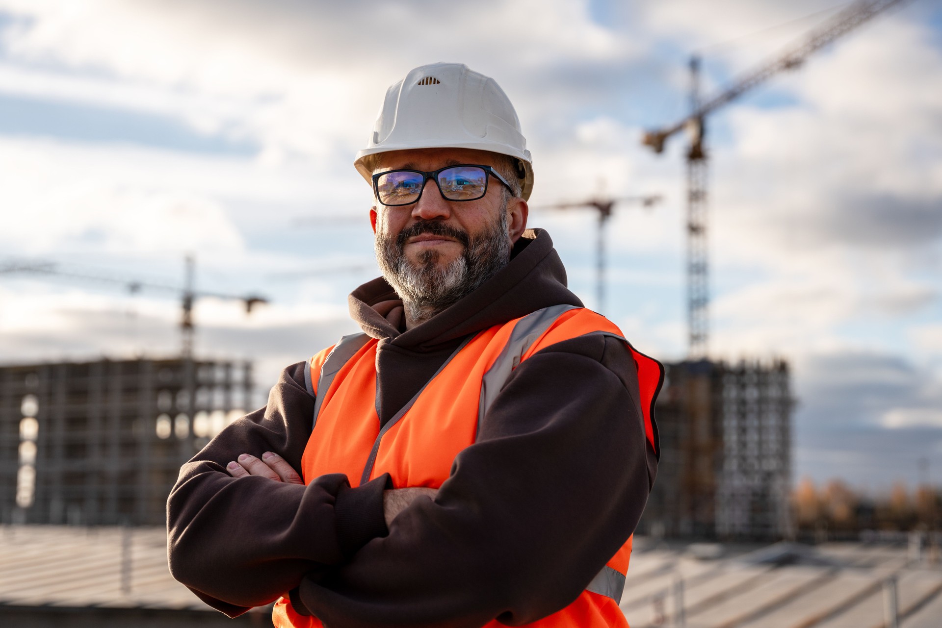 Confident Construction Worker in Hard Hat at Building Site