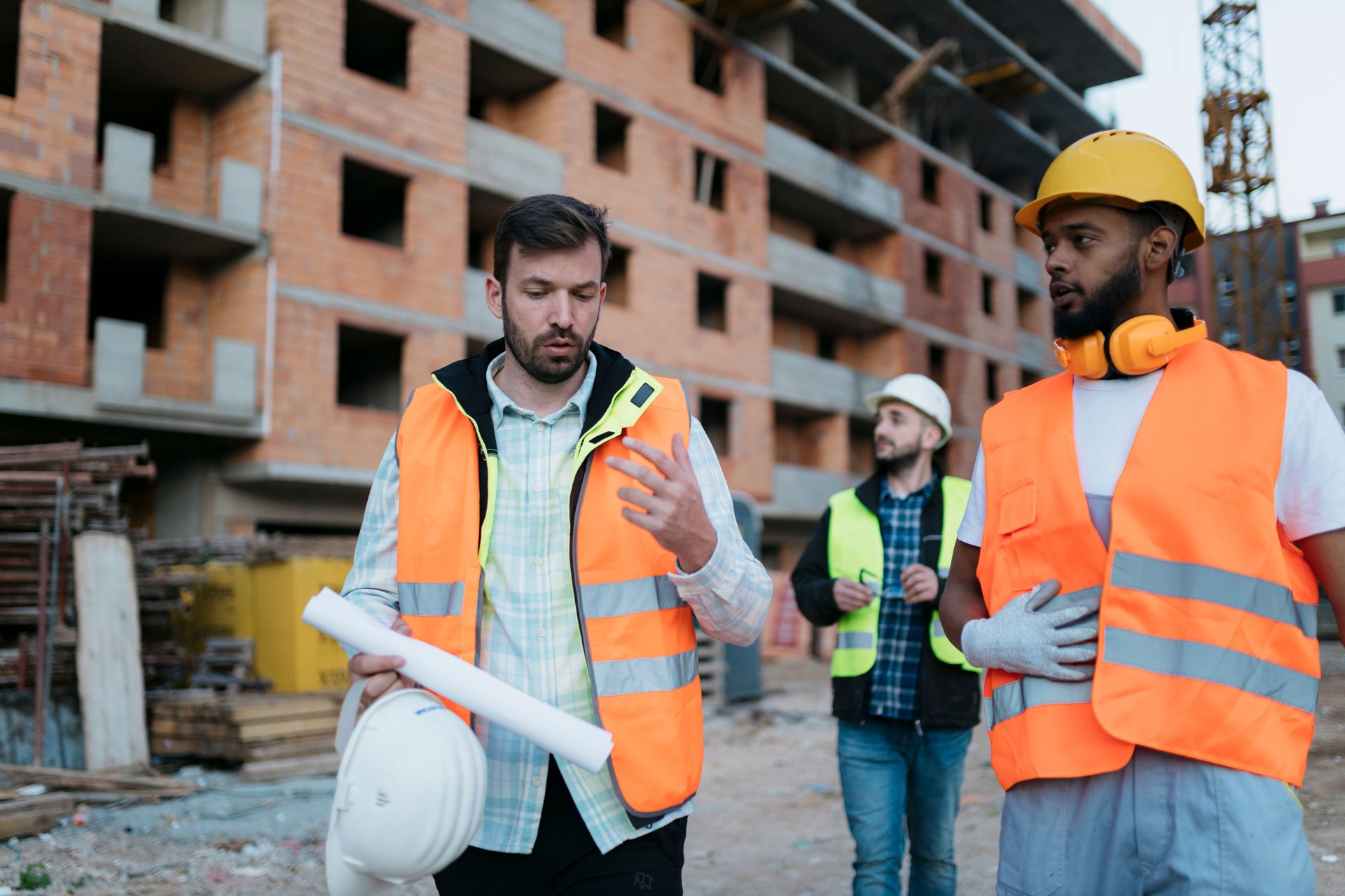 Contractors inspecting and discussing housing project on-site